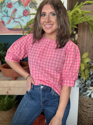 woman wearing pink gingham puff sleeve boutique top