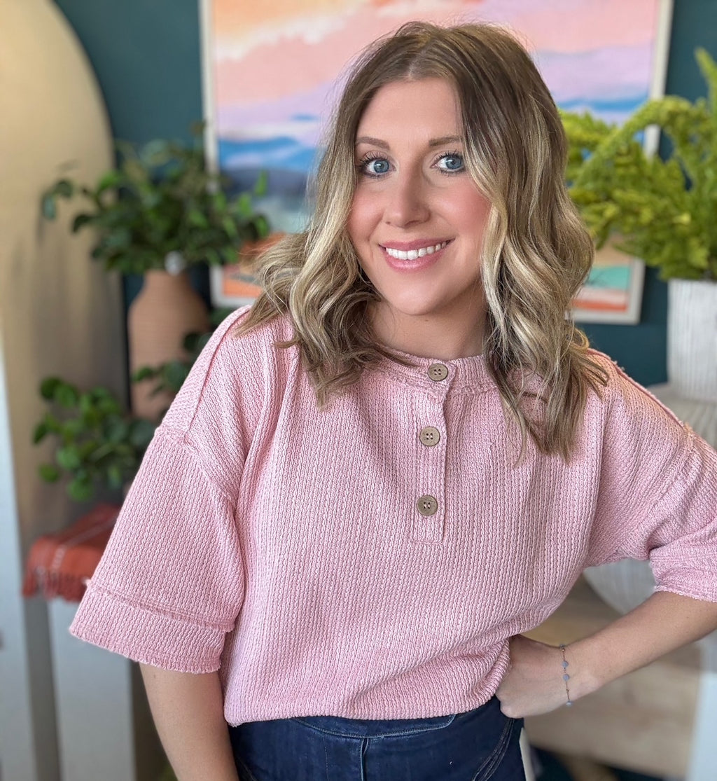 woman wearing blush pink waffle knit boutique top with button neckline