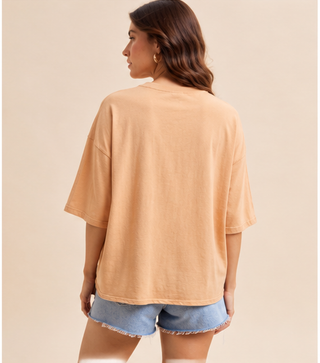 Woman wearing a camel Mallard Duck Patchwork Knit Top with plaid and floral duck appliqué and denim shorts.
