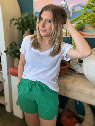 woman wearing emerald green eyelet boutique drawstring shorts
