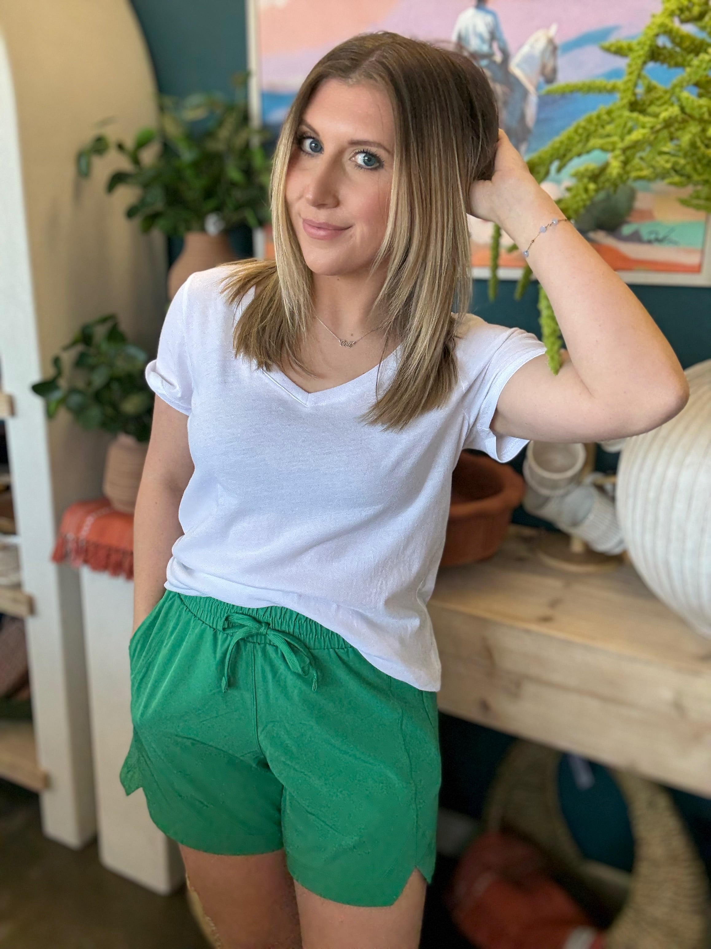 woman wearing emerald green eyelet boutique drawstring shorts