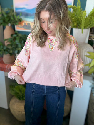woman wearing blush boutique pullover with floral contrast sleeves