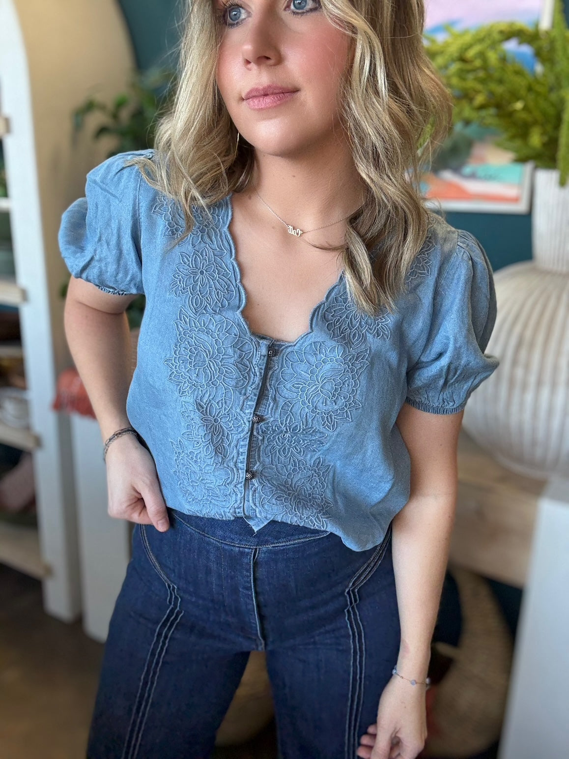 woman wearing embroidered chambray boutique top with puff sleeves and button front