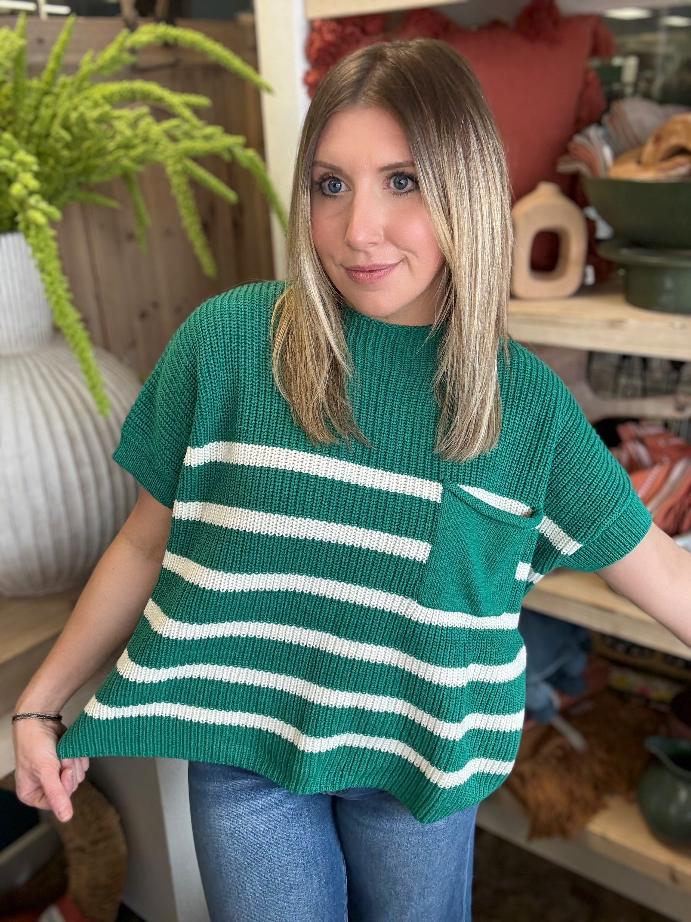 woman wearing emerald green striped boutique sweater top with pocket