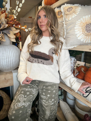Ivory women’s sweater with oversized mallard duck graphic