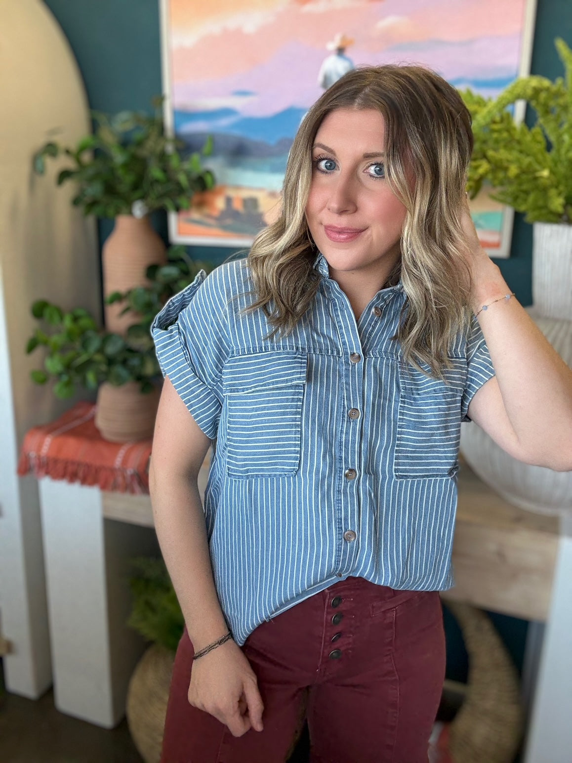 woman wearing blue and white striped boutique button-down top with front pocket
