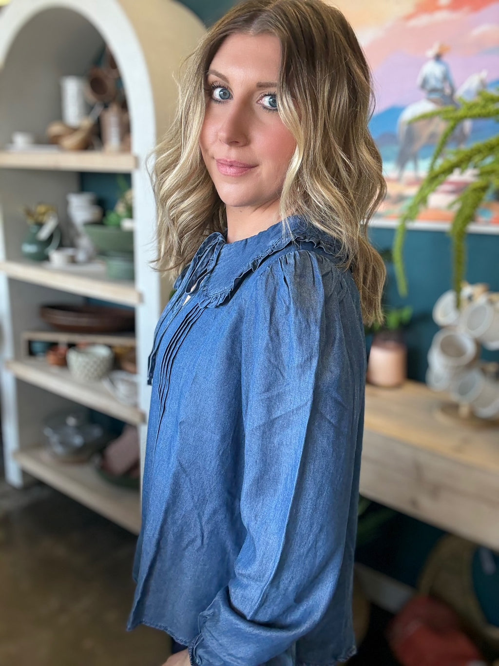 woman wearing chambray boutique blouse with tie neckline and pintuck detailing