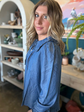 woman wearing chambray boutique blouse with tie neckline and pintuck detailing