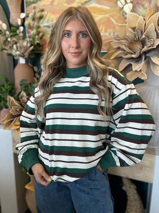 Woman wearing a teal French terry striped sweatshirt from Pill Box Boutique