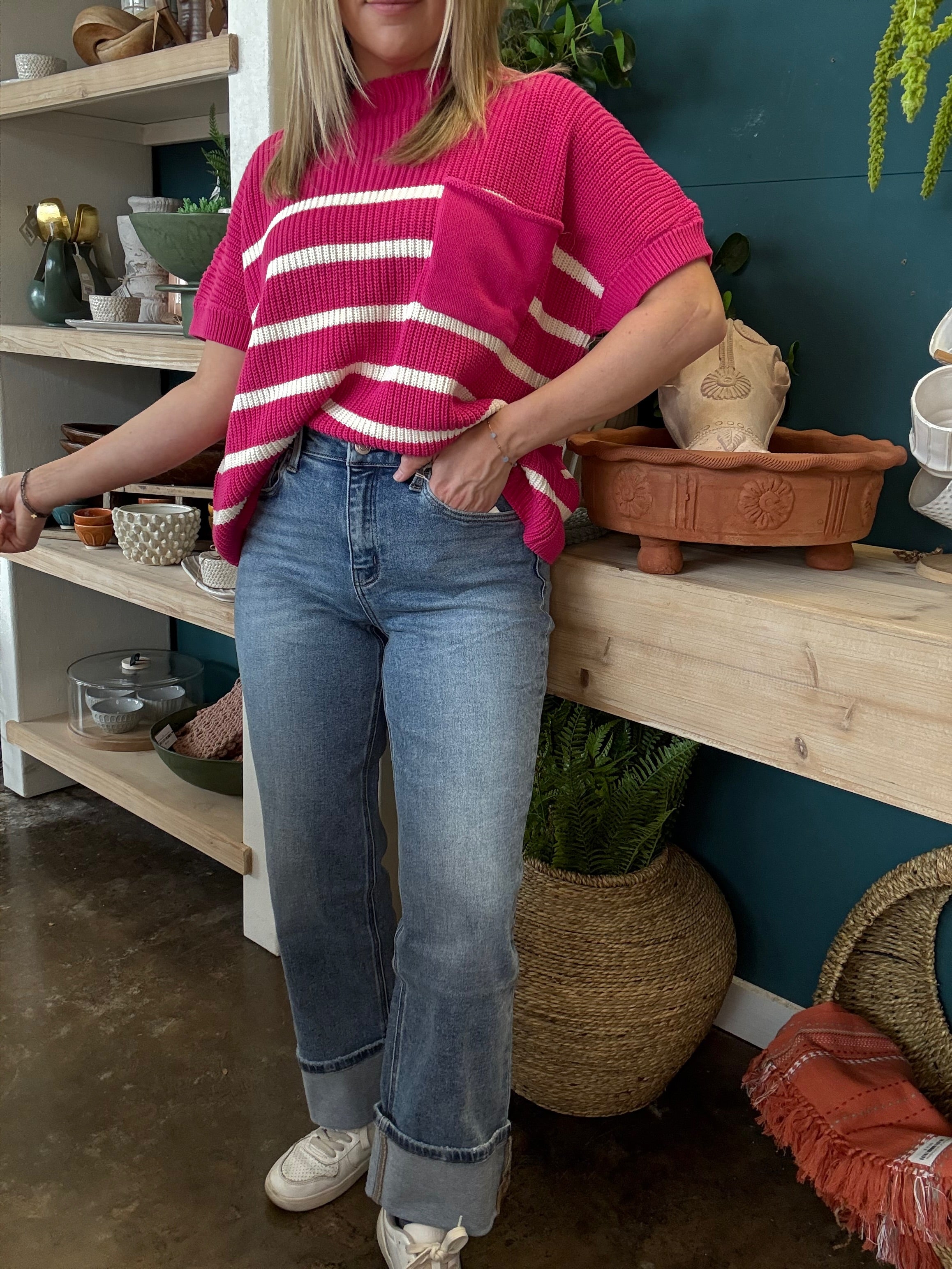 woman wearing mid rise straight leg cuffed boutique jeans
