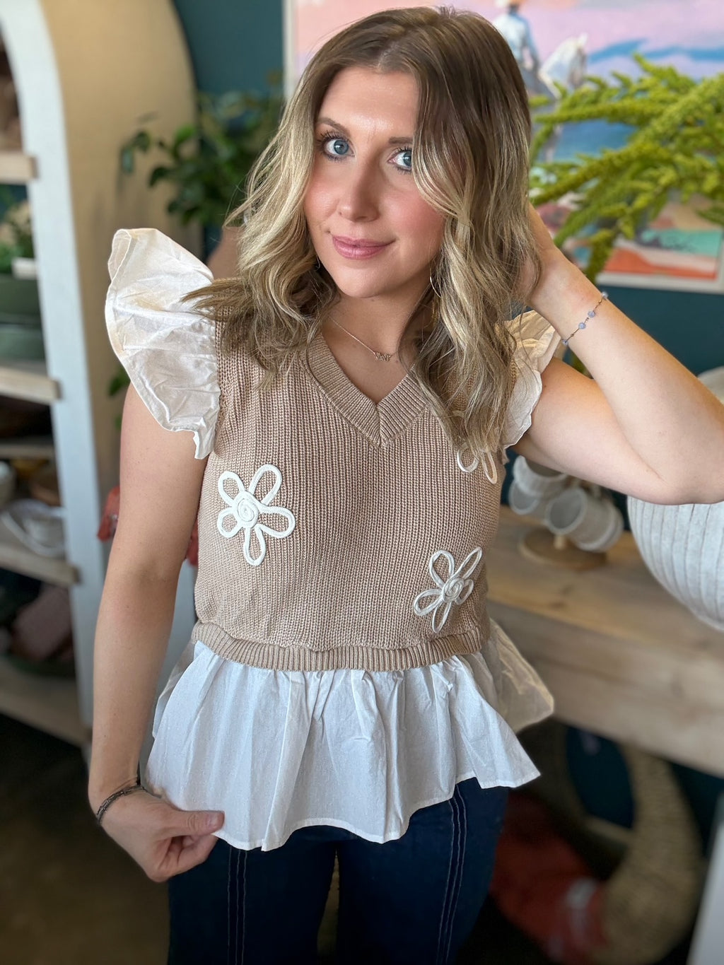 woman wearing floral ruffle knit boutique top with layered white peplum hem