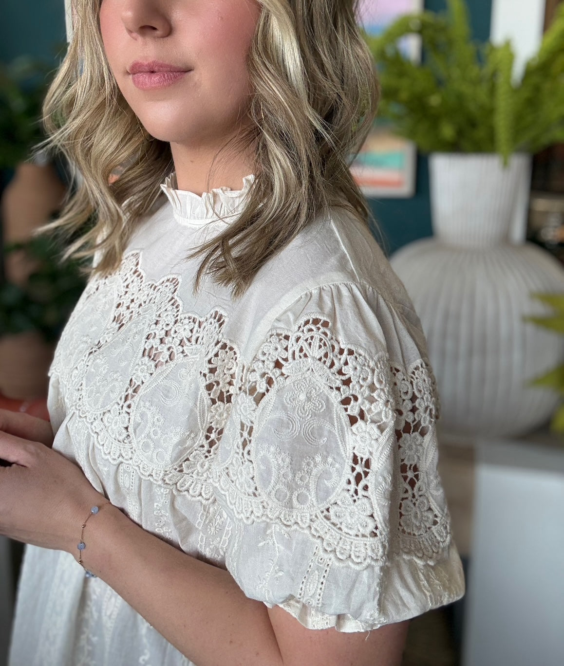 woman wearing vintage lace boutique blouse with mock neck and lace detailing