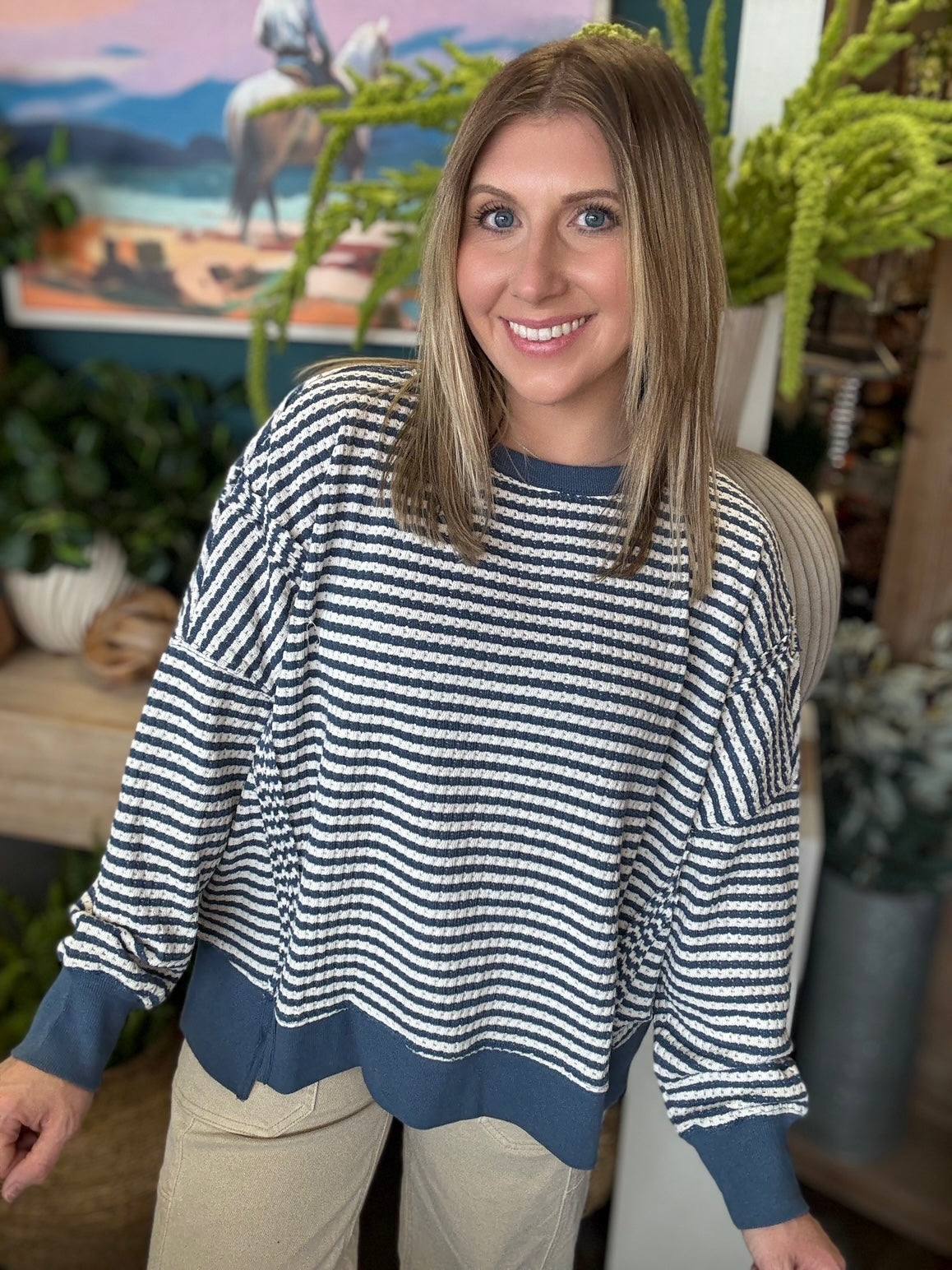 Navy and cream striped relaxed fit boutique top styled with neutral pants at Pill Box Boutique