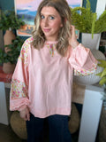 woman wearing blush boutique pullover with floral contrast sleeves