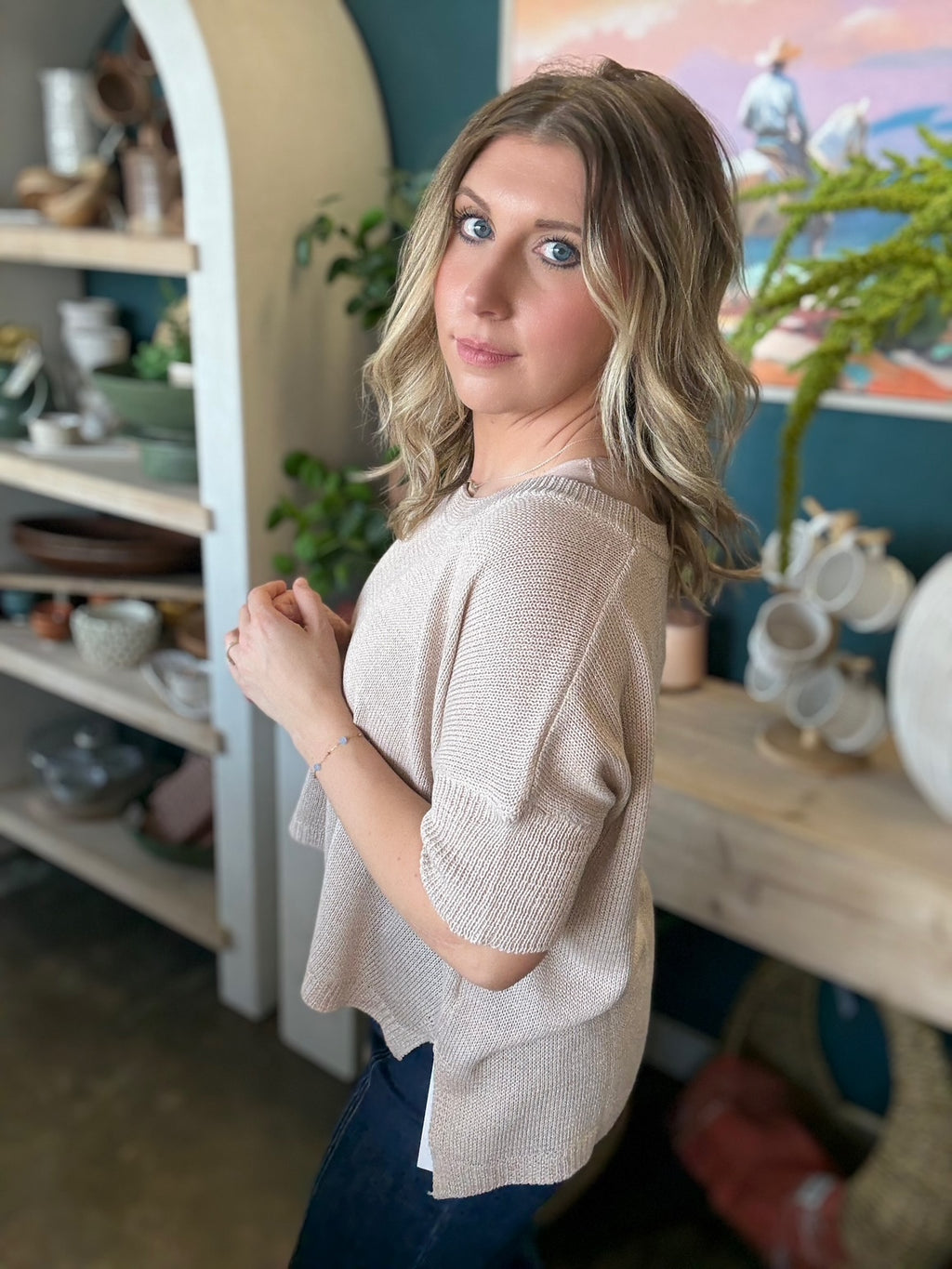 woman wearing neutral beige knit short sleeve boutique sweater top
