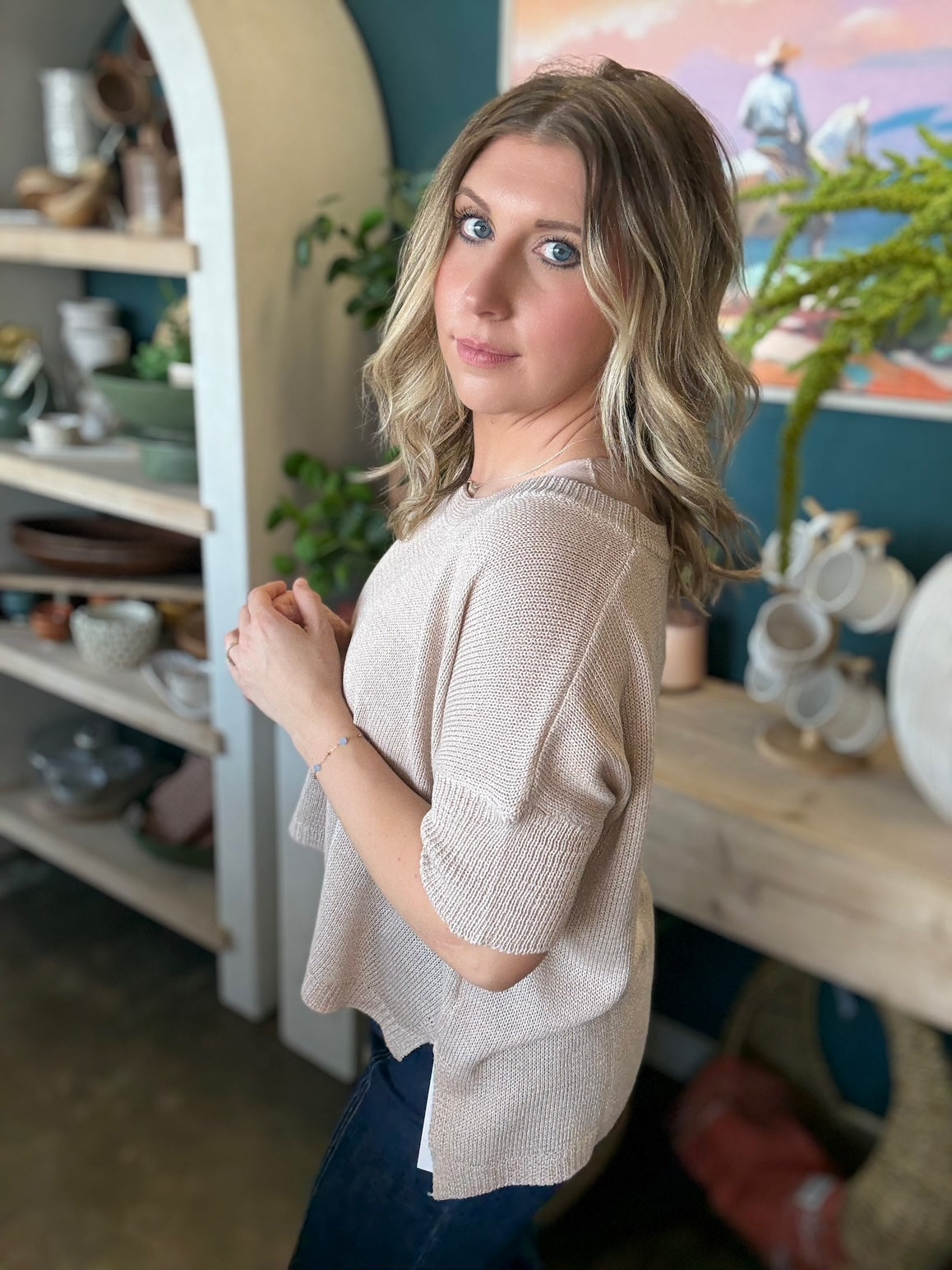 woman wearing neutral beige knit short sleeve boutique sweater top