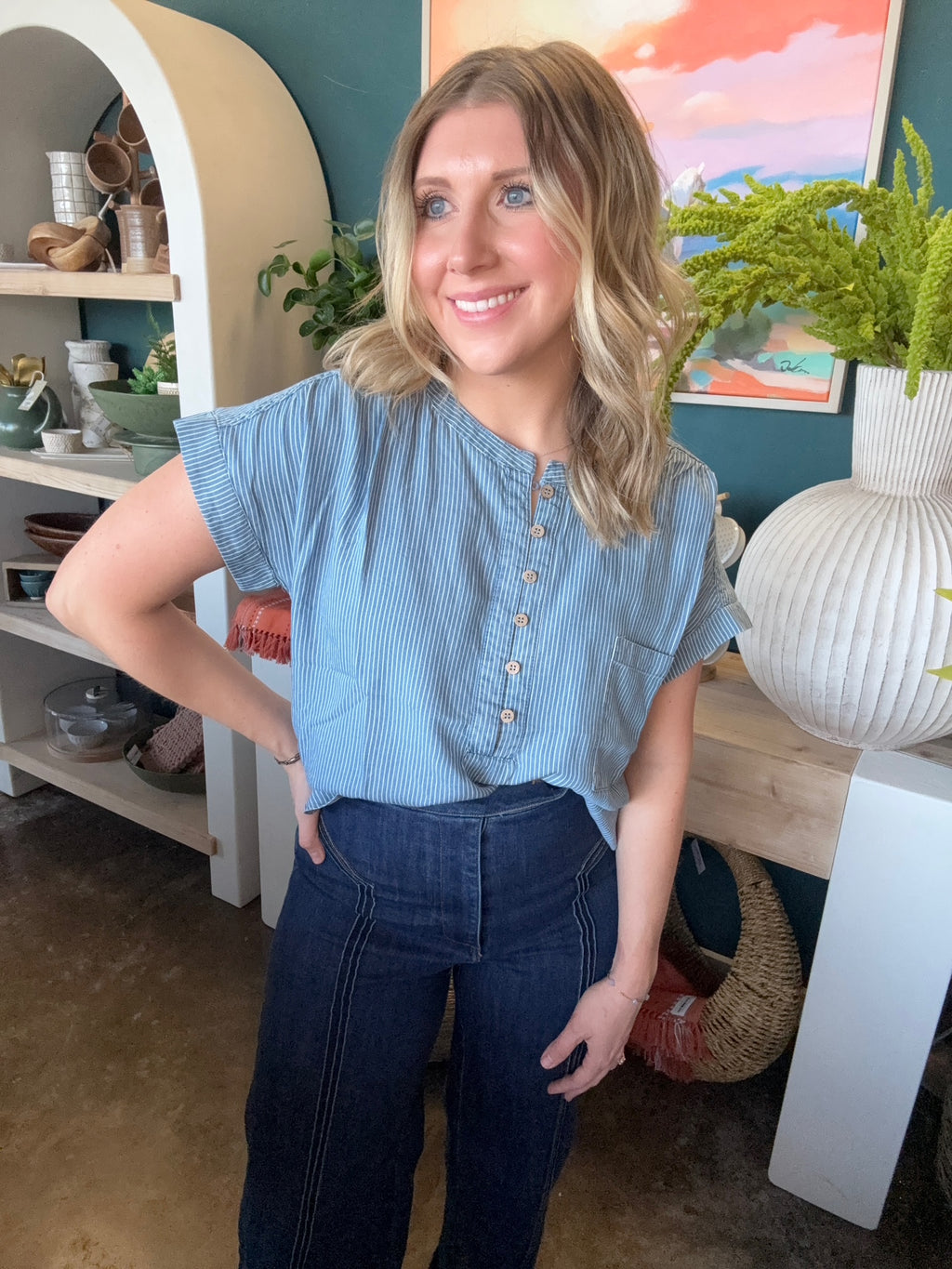 woman wearing blue and white pinstripe boutique blouse with button front