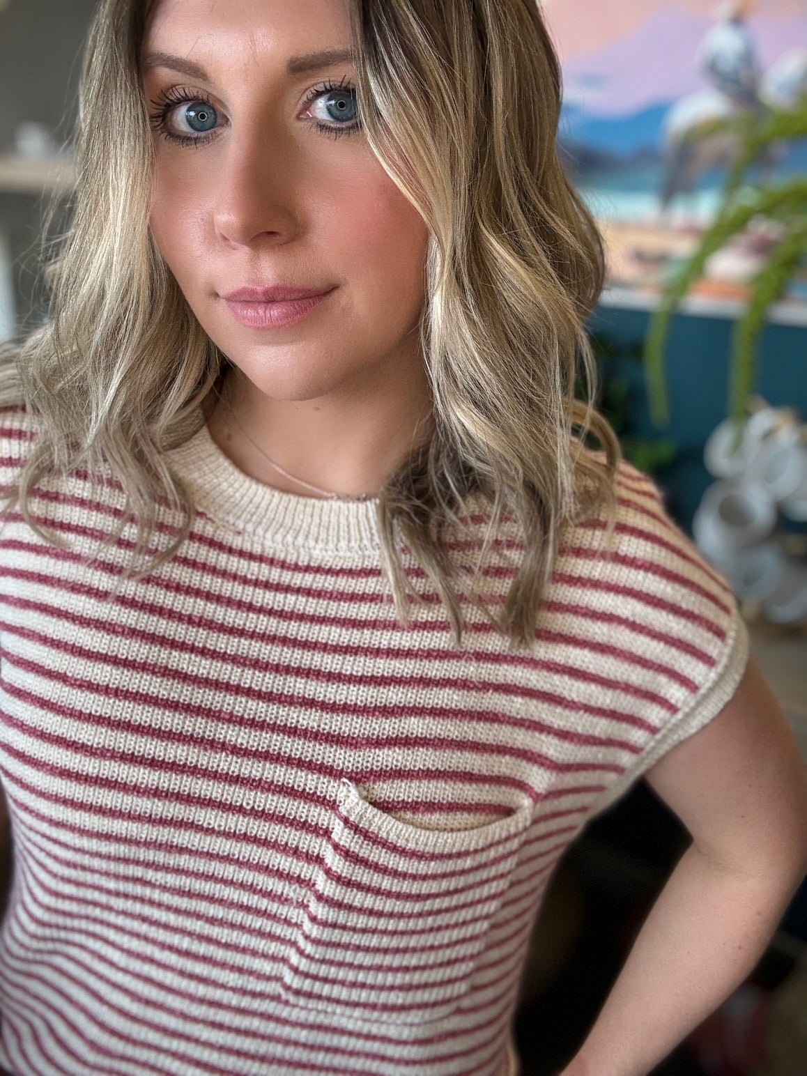 woman wearing red and cream striped boutique knit top with pocket
