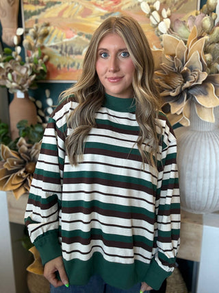 Woman wearing a teal French terry striped sweatshirt from Pill Box Boutique