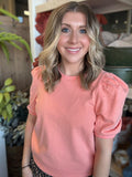 woman wearing coral puff sleeve boutique knit top