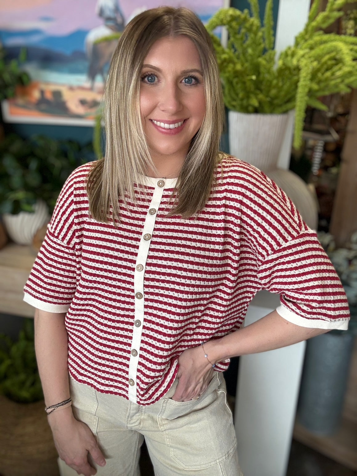 Red and cream striped button front boutique top styled with neutral pants at Pill Box Boutique