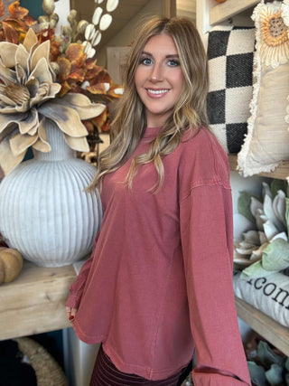 Woman wearing a winter-berry mineral-wash long-sleeve tee with dropped shoulders and balloon sleeves