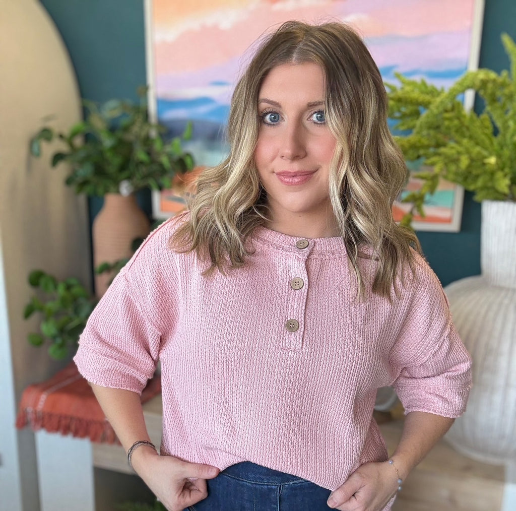 woman wearing blush pink waffle knit boutique top with button neckline