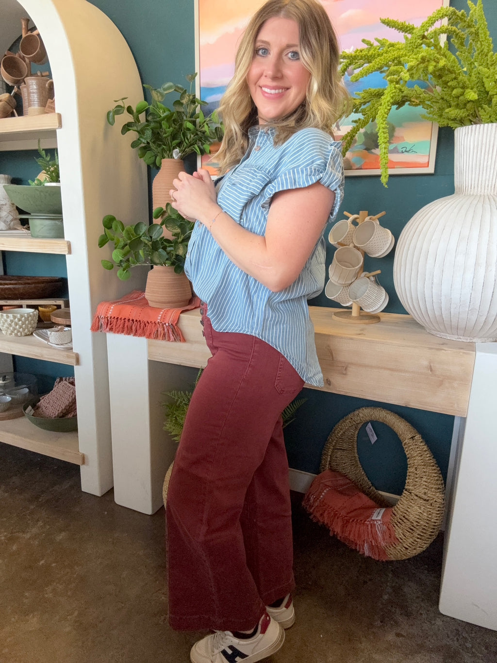 woman wearing rust high waisted button front wide leg boutique pants