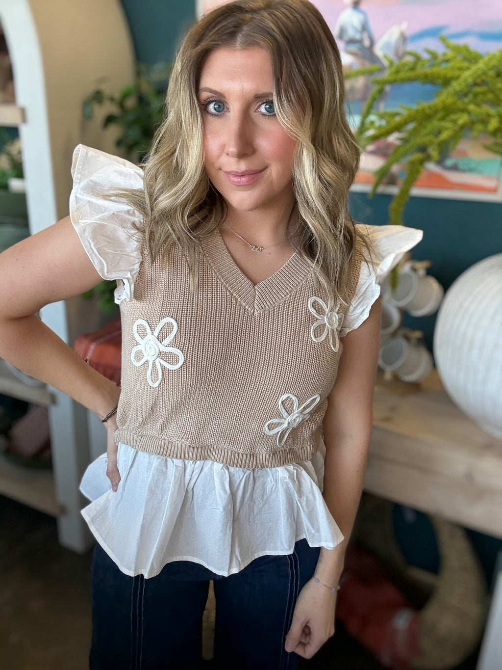 woman wearing floral ruffle knit boutique top with layered white peplum hem