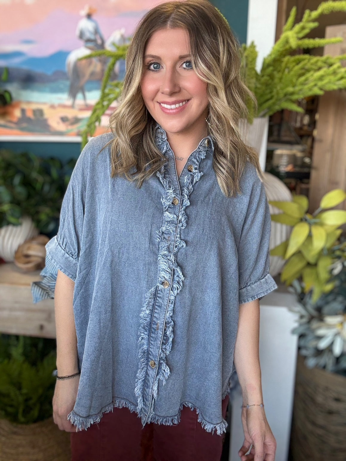 woman wearing frayed chambray boutique button-up top