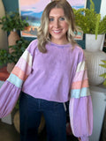 woman wearing lavender boutique pullover with pastel tiered sleeves