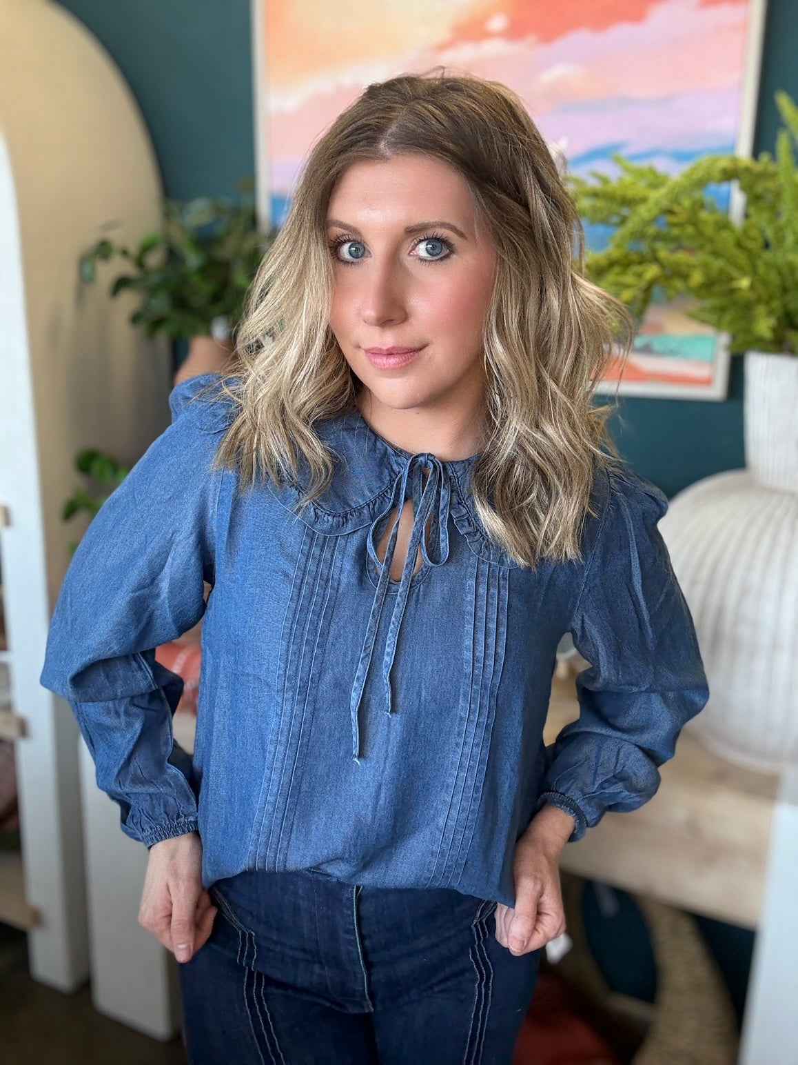 woman wearing chambray boutique blouse with tie neckline and pintuck detailing