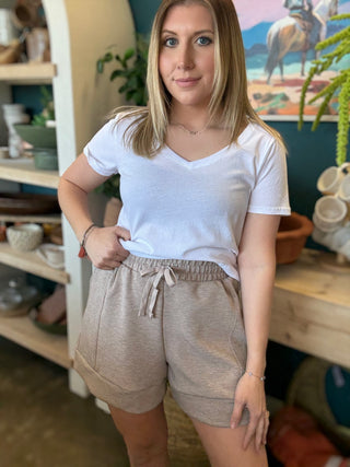 woman wearing neutral drawstring boutique lounge shorts with pockets