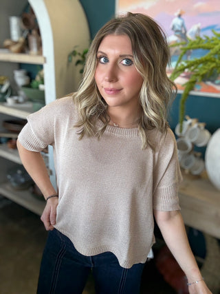 woman wearing neutral beige knit short sleeve boutique sweater top