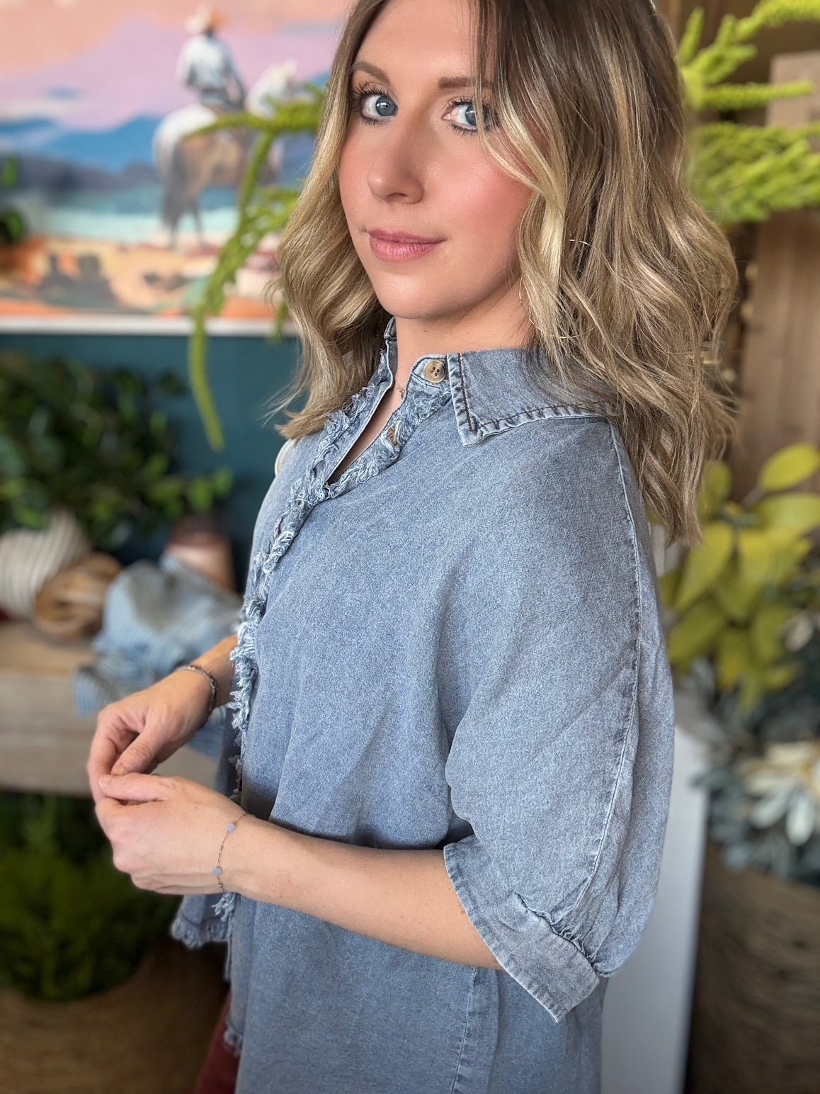 woman wearing frayed chambray boutique button-up top