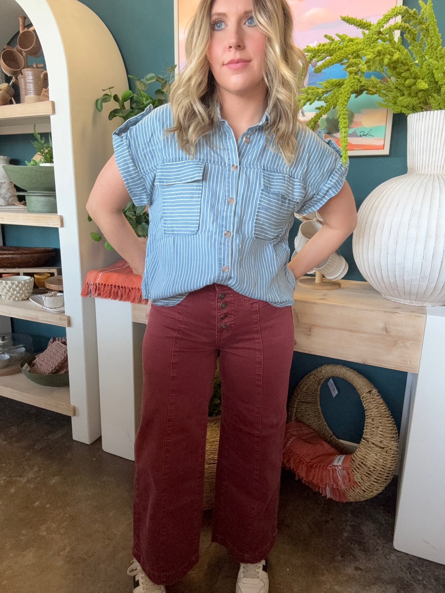 woman wearing blue and white striped boutique button-down top with front pocket