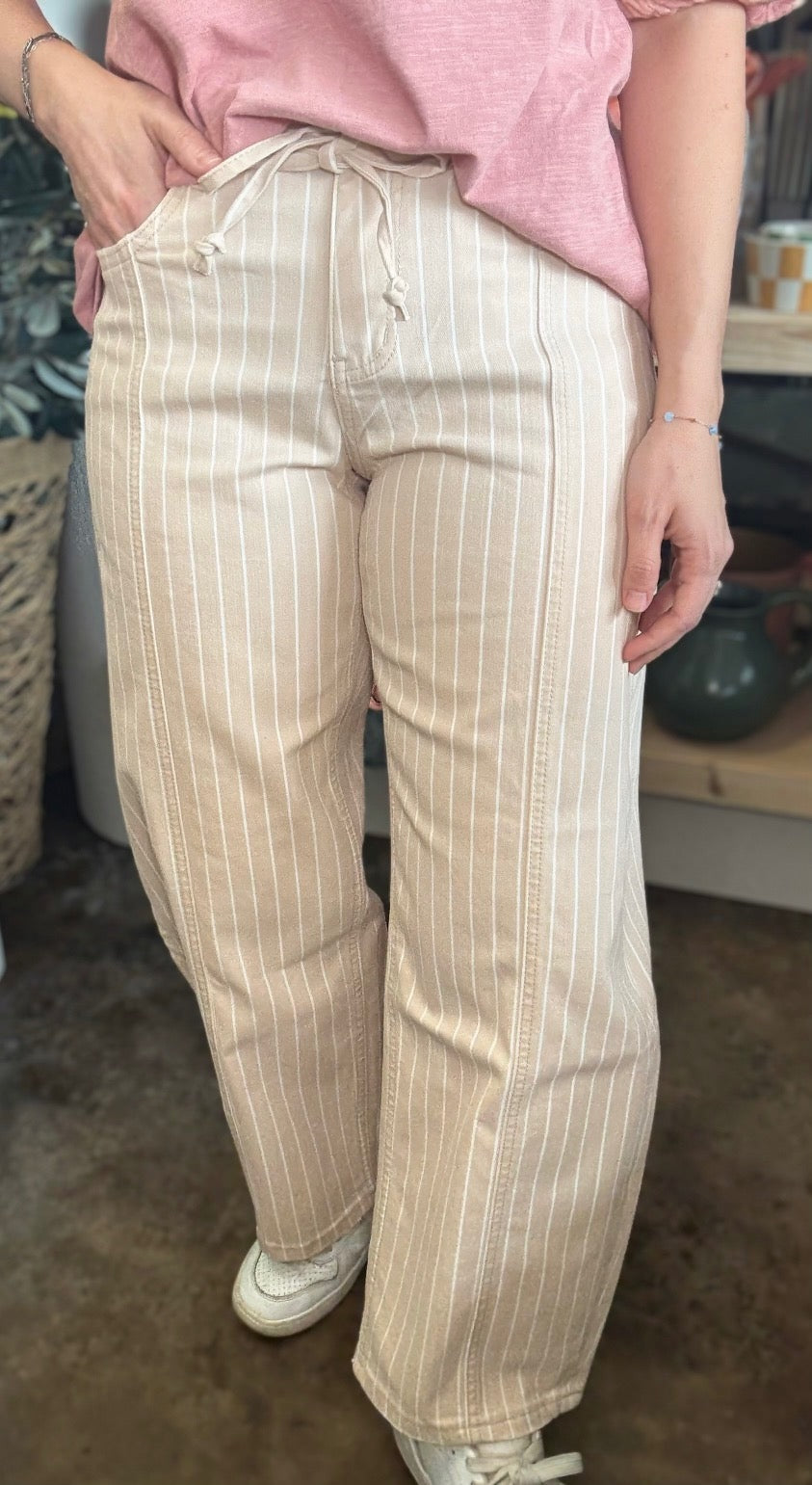woman wearing sand striped drawstring boutique straight leg pants