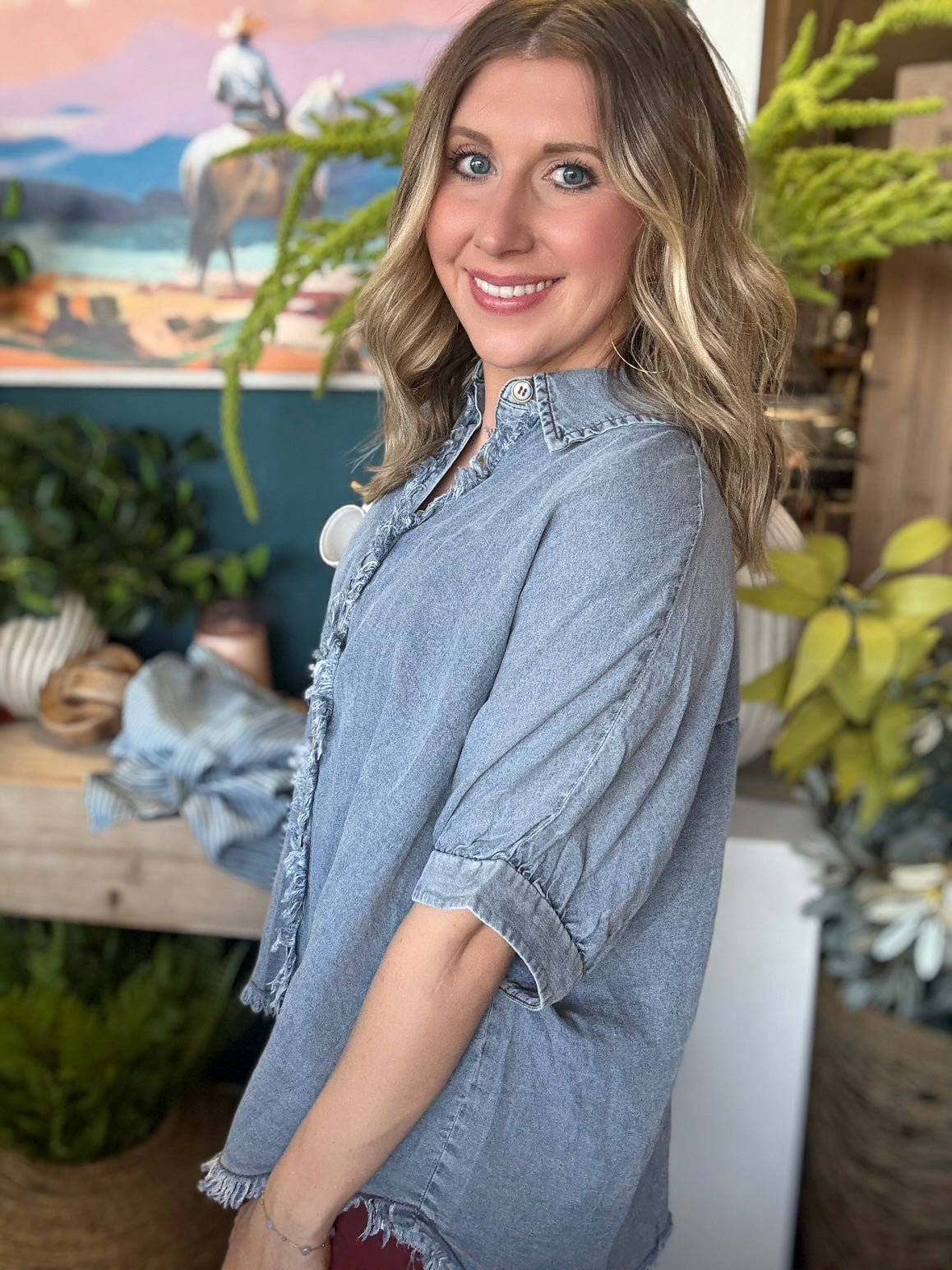 woman wearing frayed chambray boutique button-up top