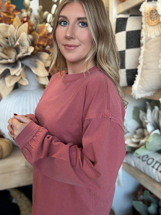 Woman wearing a winter-berry mineral-wash long-sleeve tee with dropped shoulders and balloon sleeves