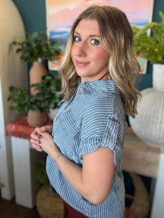 woman wearing blue and white striped boutique button-down top with front pocket