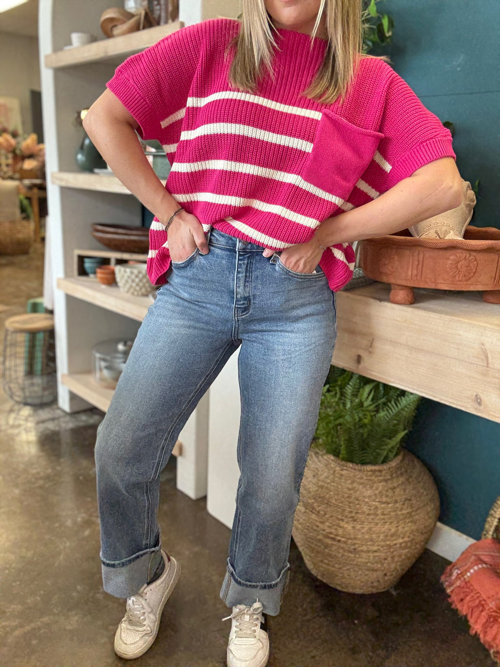 woman wearing mid rise straight leg cuffed boutique jeans