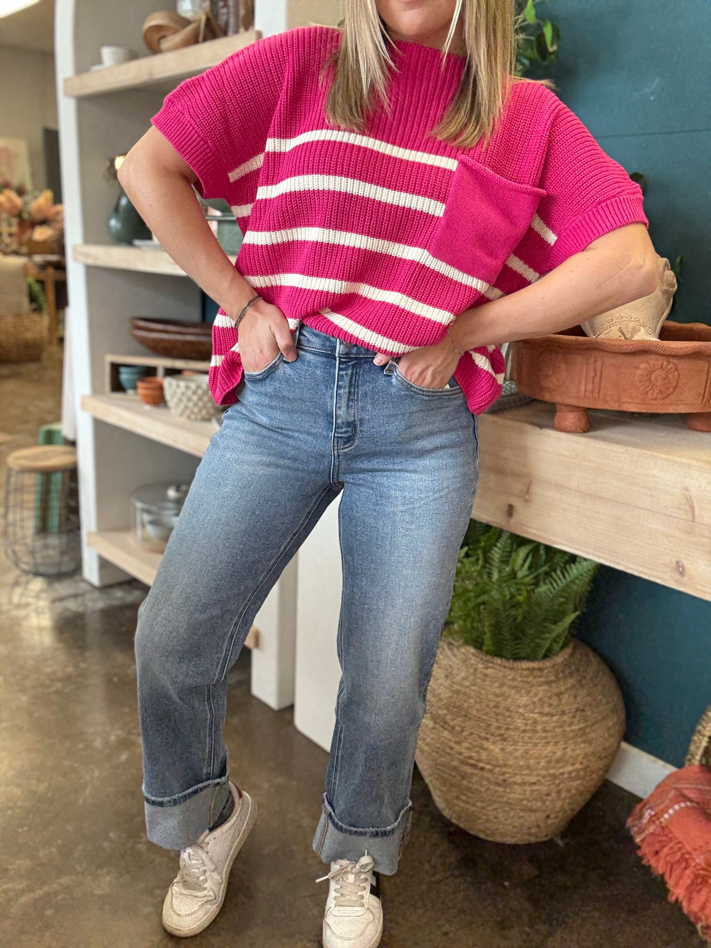 woman wearing mid rise straight leg cuffed boutique jeans