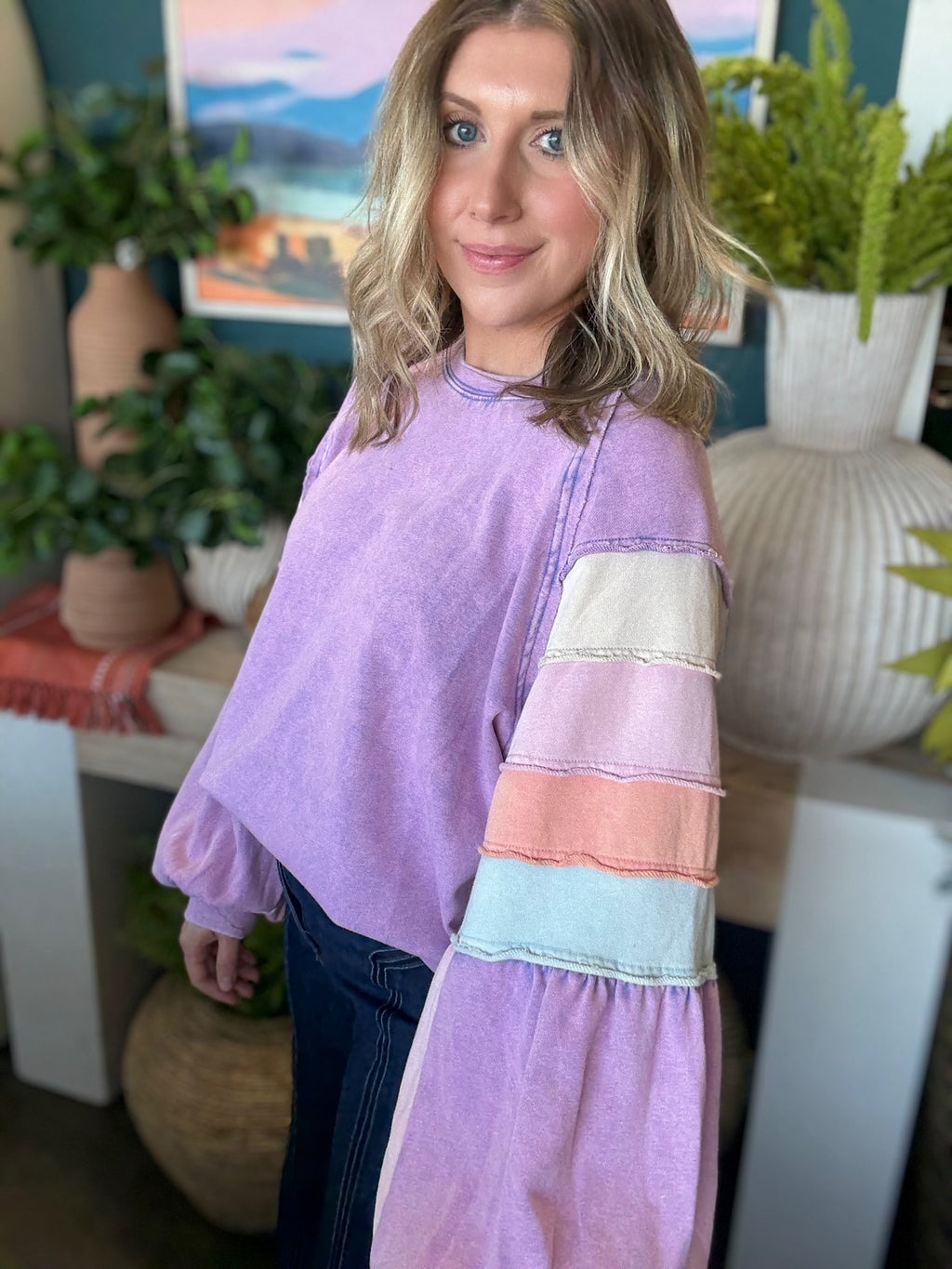 woman wearing lavender boutique pullover with pastel tiered sleeves