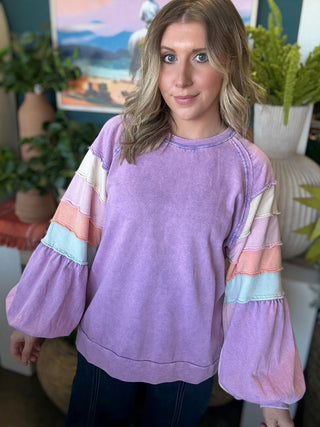 woman wearing lavender boutique pullover with pastel tiered sleeves