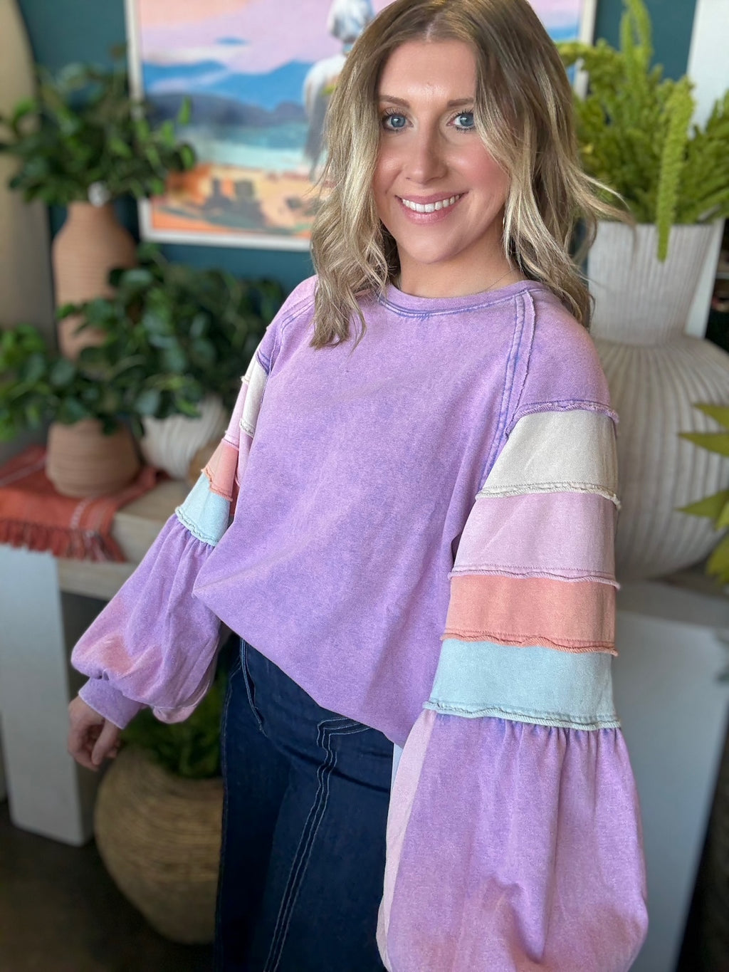 woman wearing lavender boutique pullover with pastel tiered sleeves