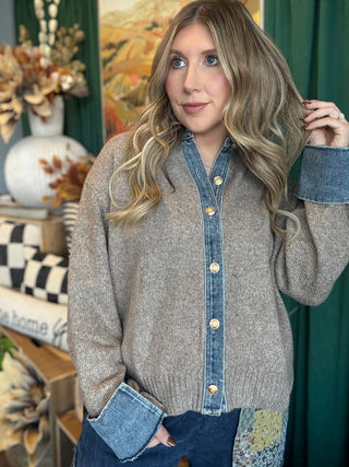 Woman wearing a latte knit sweater with a washed-denim collar, button placket, statement cuffs, and gold-tone buttons.