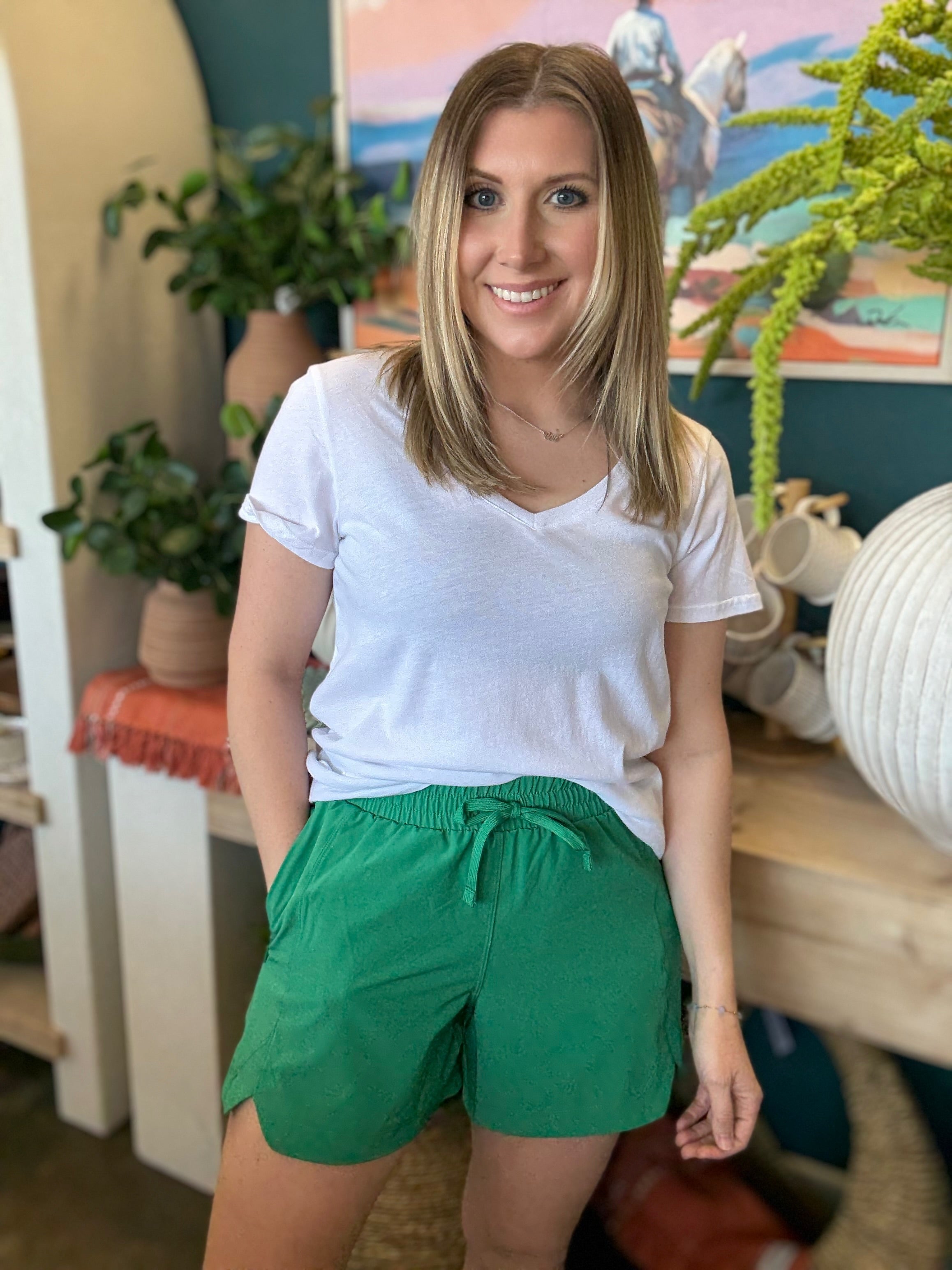 woman wearing emerald green eyelet boutique drawstring shorts