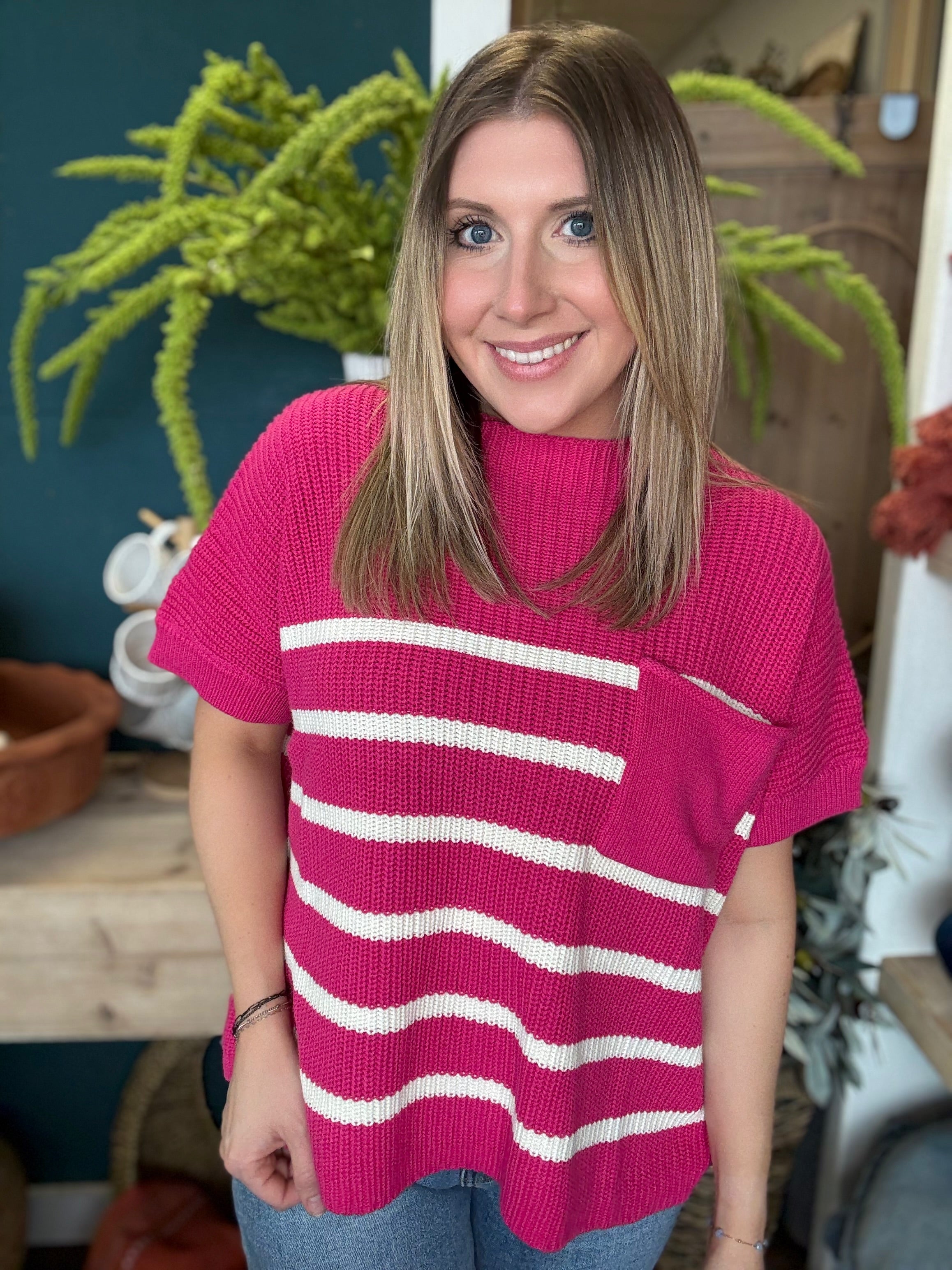 woman wearing bright pink striped boutique sweater top with pocket
