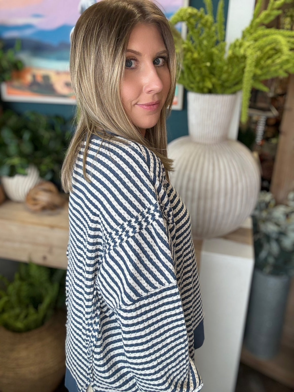 Navy and cream striped relaxed fit boutique top styled with neutral pants at Pill Box Boutique