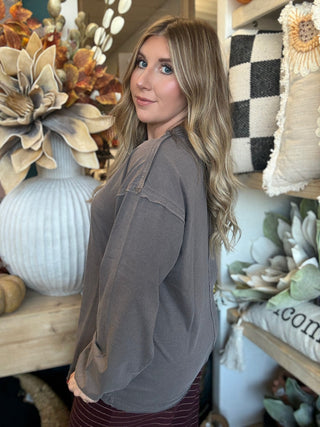 Woman wearing an oversized mocha mineral-wash long-sleeve tee with a crew neckline and gathered cuffs